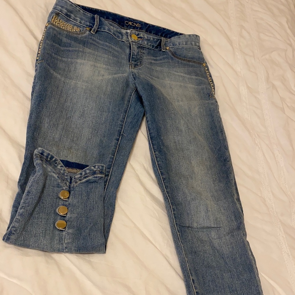 Light blue cropped jeans with golden studs..